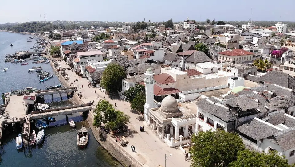 Aerial view over the historic waterfront and coral-stone buildings of Lamu Old Town